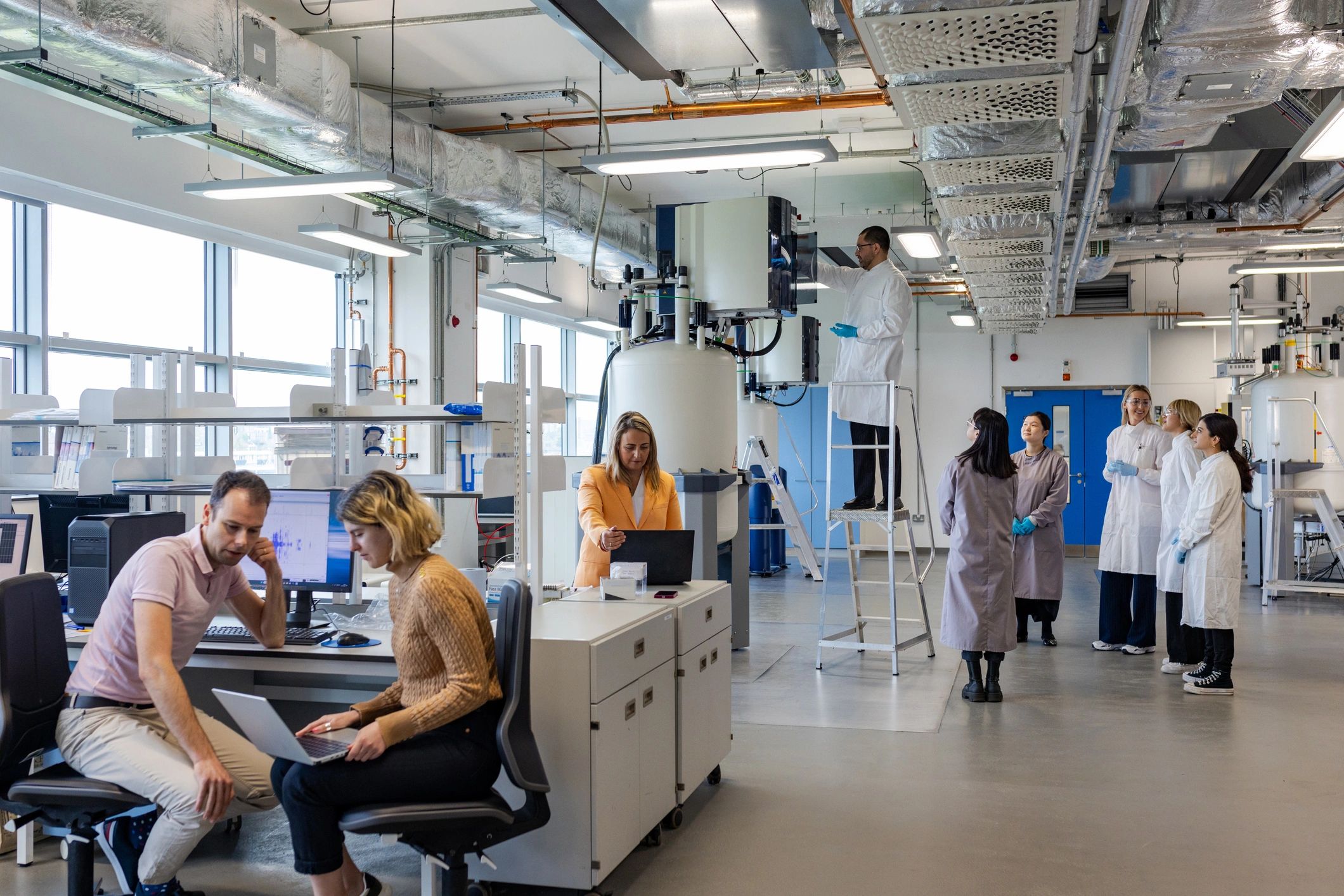 Scientists discussing test results in an active laboratory