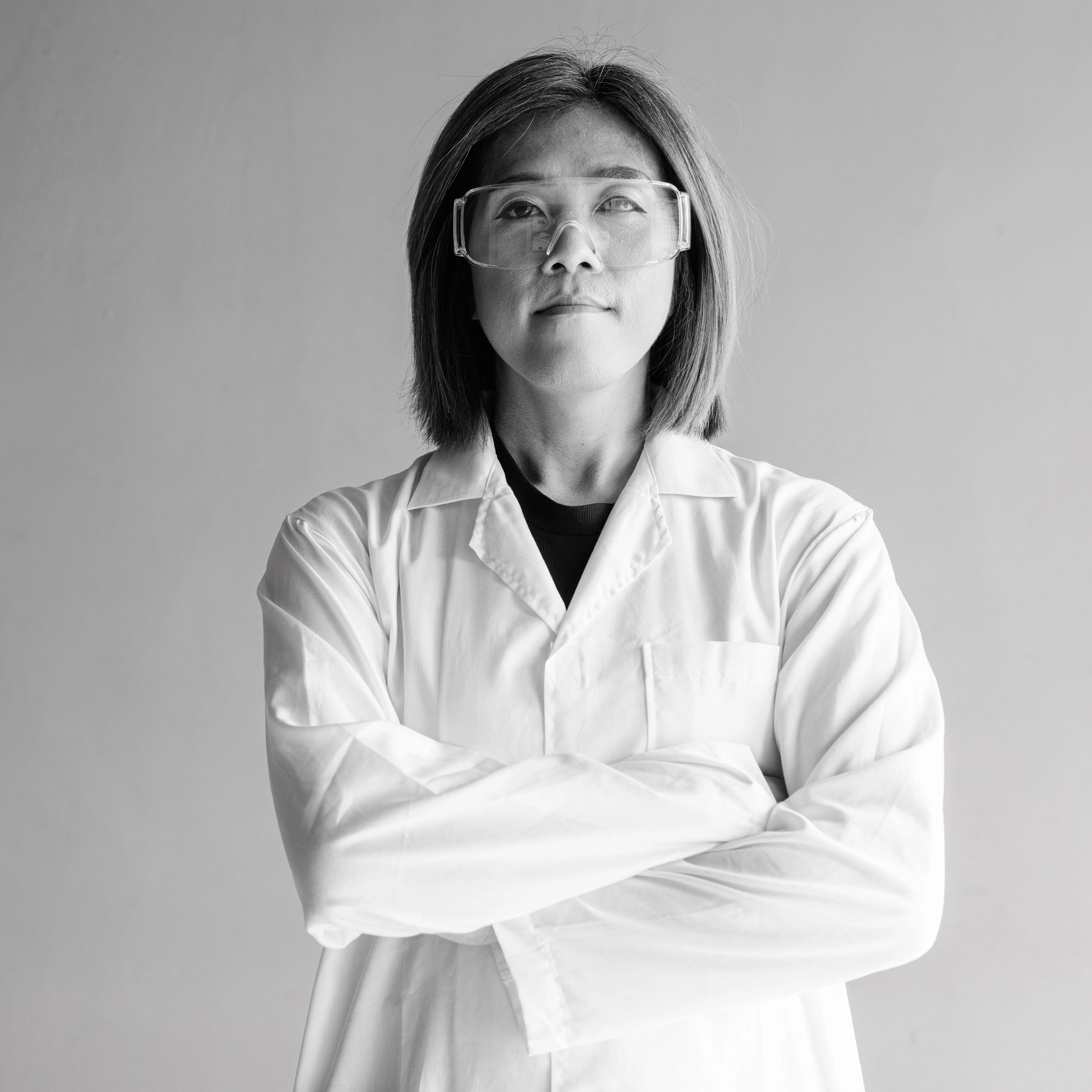 Laboratory professional in coat and protective glasses